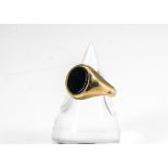 A contemporary 9ct gold and onyx gentleman's signet ring, the oval onyx slightly raised on a