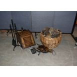 A collection of fire furniture, including an oak coal scuttle, irons, log basket and bellows