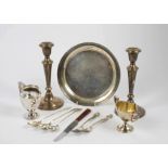 A collection of silver and silver plate, including a pair of Gorham candlesticks, milk jugs, cups,