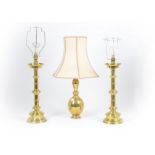 A pair of brass table lamps, converted from candlesticks, knopped column, stepped base; together