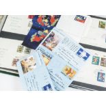A collection of World stamps and other items, in three green folders and albums, FDCs, three pre-
