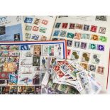 A collection of stamps, loose and in albums, a diverse variety of vintage and modern, with some face