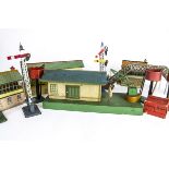 Hornby 0 Gauge Pre-war Goods Shed and Post-war Scenic Items, the goods shed on green base with red/