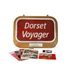 A 'Dorset Voyager' Name Plate, a commemorative aluminium nameplate 'Dorset Voyager', on a red