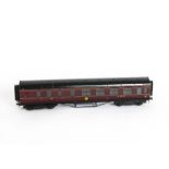 An Exley 0 Gauge LMS Corridor Brake/3rd class Coach, in LMS maroon, with shaded transfer running