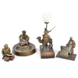 A group of cold painted spelter models of Arabic figures, including a table lamp with a mounter