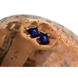 A pair of lapis lazuli and sapphire set cufflinks, the graduated square lapis lazuli terminals