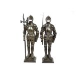 A pair of cast metal Nestor fire iron stands in the form of medieval knights, one with a poker