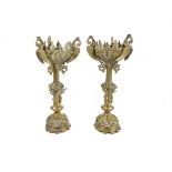 A pair of brass candlesticks, knopped stems with applied scroll decoration, pierced scroll decorated