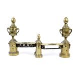 A pair of 19th Century French Louis XVI style brass chenets, each with a twin-handled urn, and