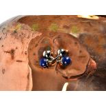 A pair of white metal and lapis lazuli cufflinks, the spherical beads on fixed white metal batons