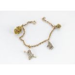 A 9ct gold fancy link bracelet, with four gem set charms including a diamond encrusted hand set in