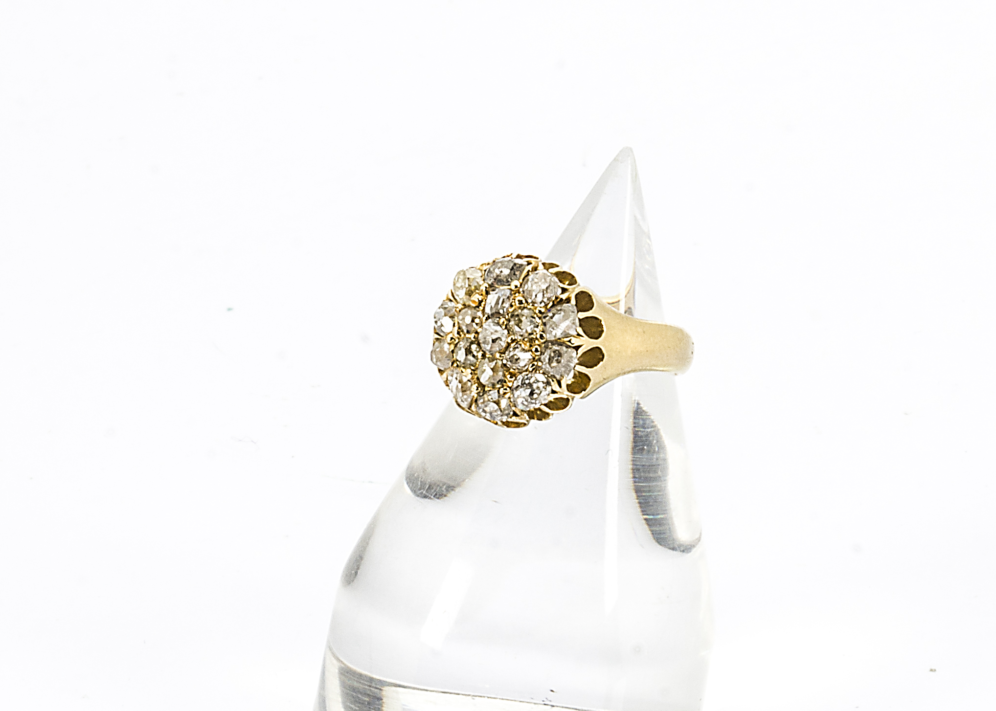 A Victorian 18ct gold diamond set cluster ring, the old cuts in claw settings on a plain yellow gold