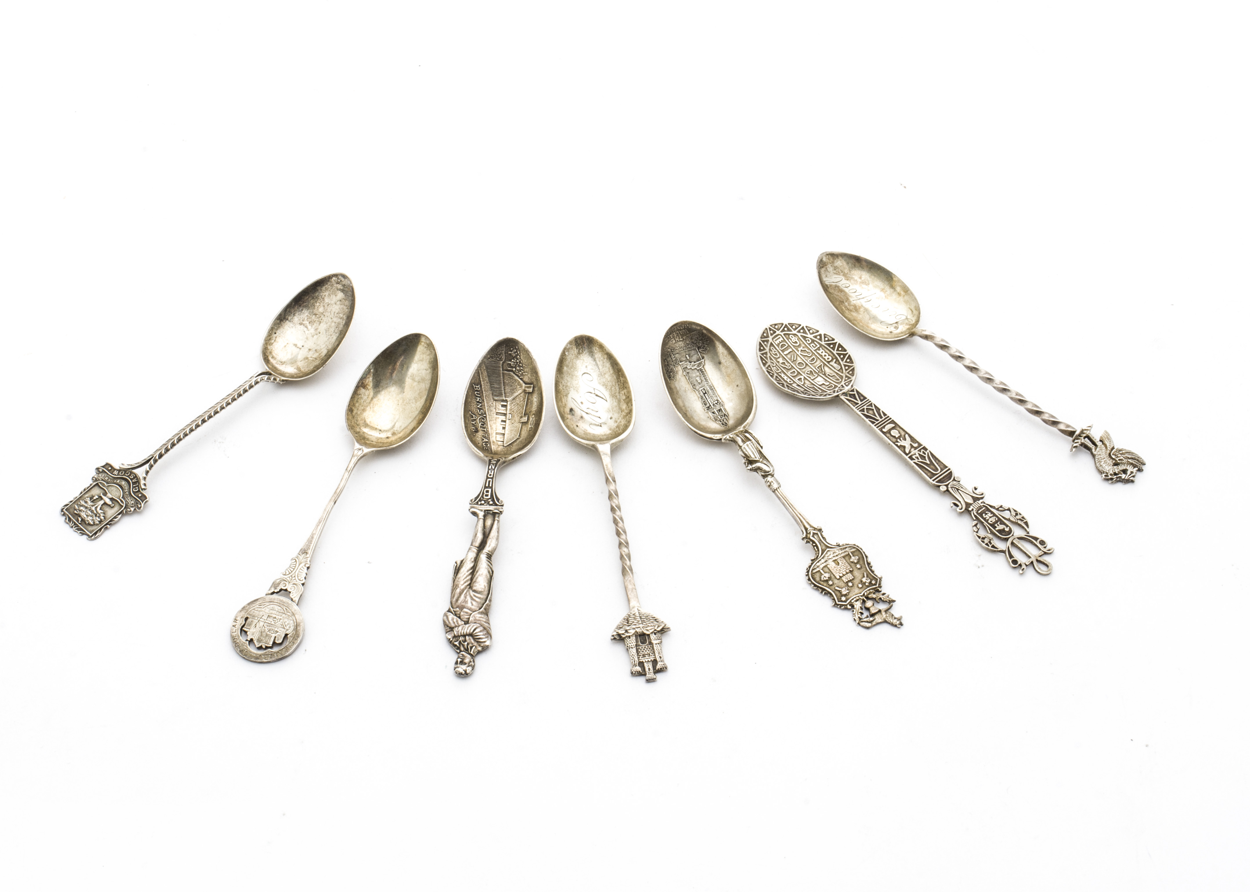 Seven silver souvenir teaspoons, one from Egypt, another marked The Burgh of Dollar and four