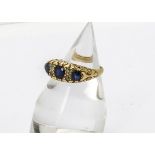 An Edwardian sapphire and diamond ring, the three oval mixed cut sapphires set with old cut diamonds