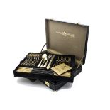 A modern canteen of gold plated cutlery by SBS, in briefcase, unused, together with a silver