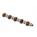 A Chinese white metal and agate bracelet, the five cabochons set in floral oval mounts alternately