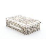An early to mid 20th Century Middle Eastern silver cigarette box, rectangular with ornate raised