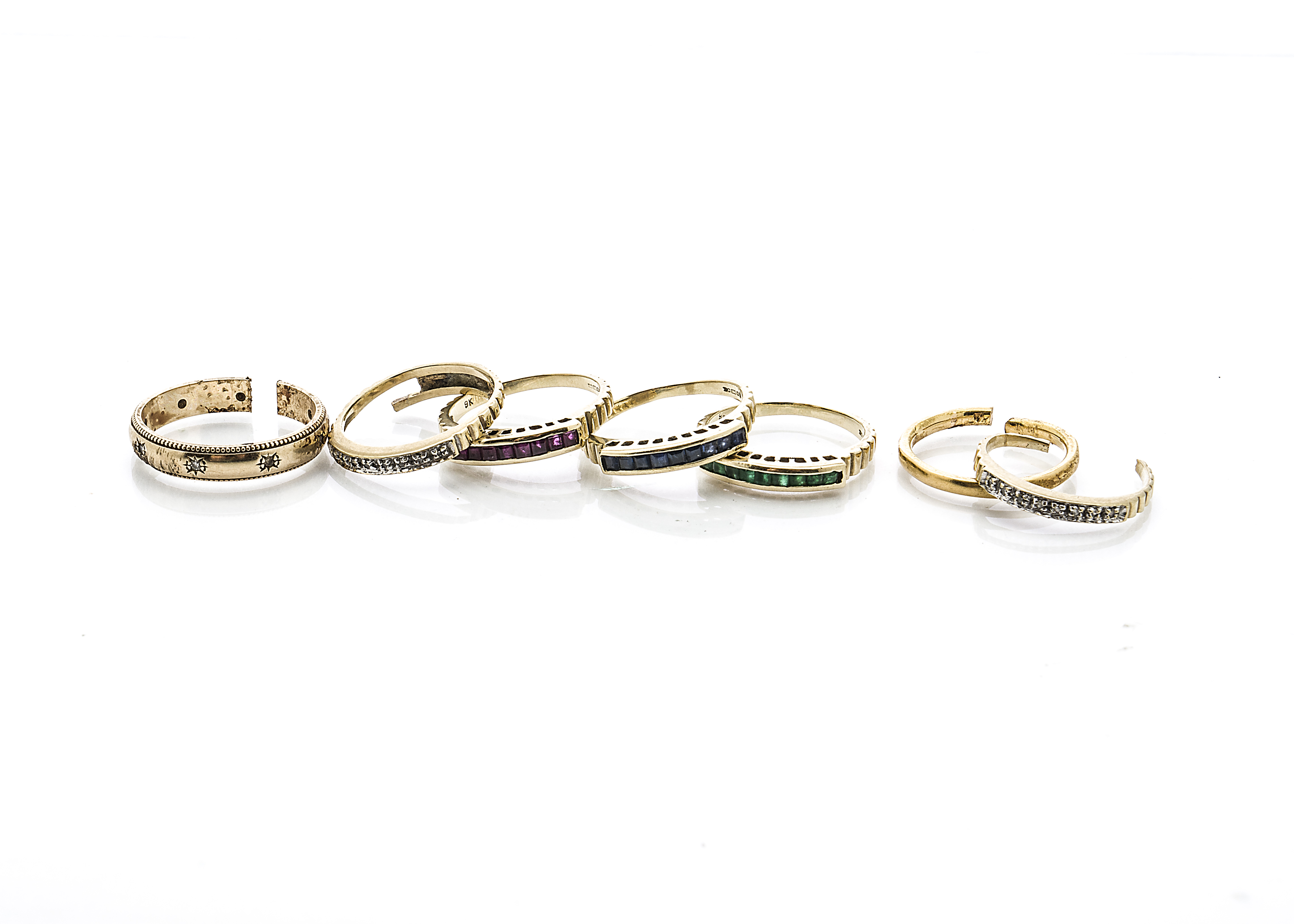 A continental yellow metal and gem set stacker ring, af, together with two gold wedding bands,