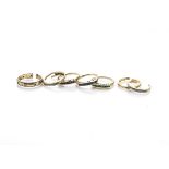 A continental yellow metal and gem set stacker ring, af, together with two gold wedding bands,