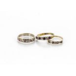 Two ruby and diamond gem set rings, in yellow metal, one paste example set in white metal (3)