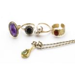 Three gold gem set dress rings, comprising an amethyst cabochon, ring size J, a sapphire and diamond