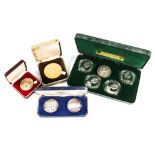 A 1980 Olympics Isle of Man silver proof four coins set from Pobjoy Mint, together with a pair of