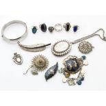 A large quantity of silver jewellery, including various gem set rings, filigree floral brooches, a