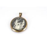 An early 19th Century gold on copper glazed circular pendant, with ivory miniature depicting