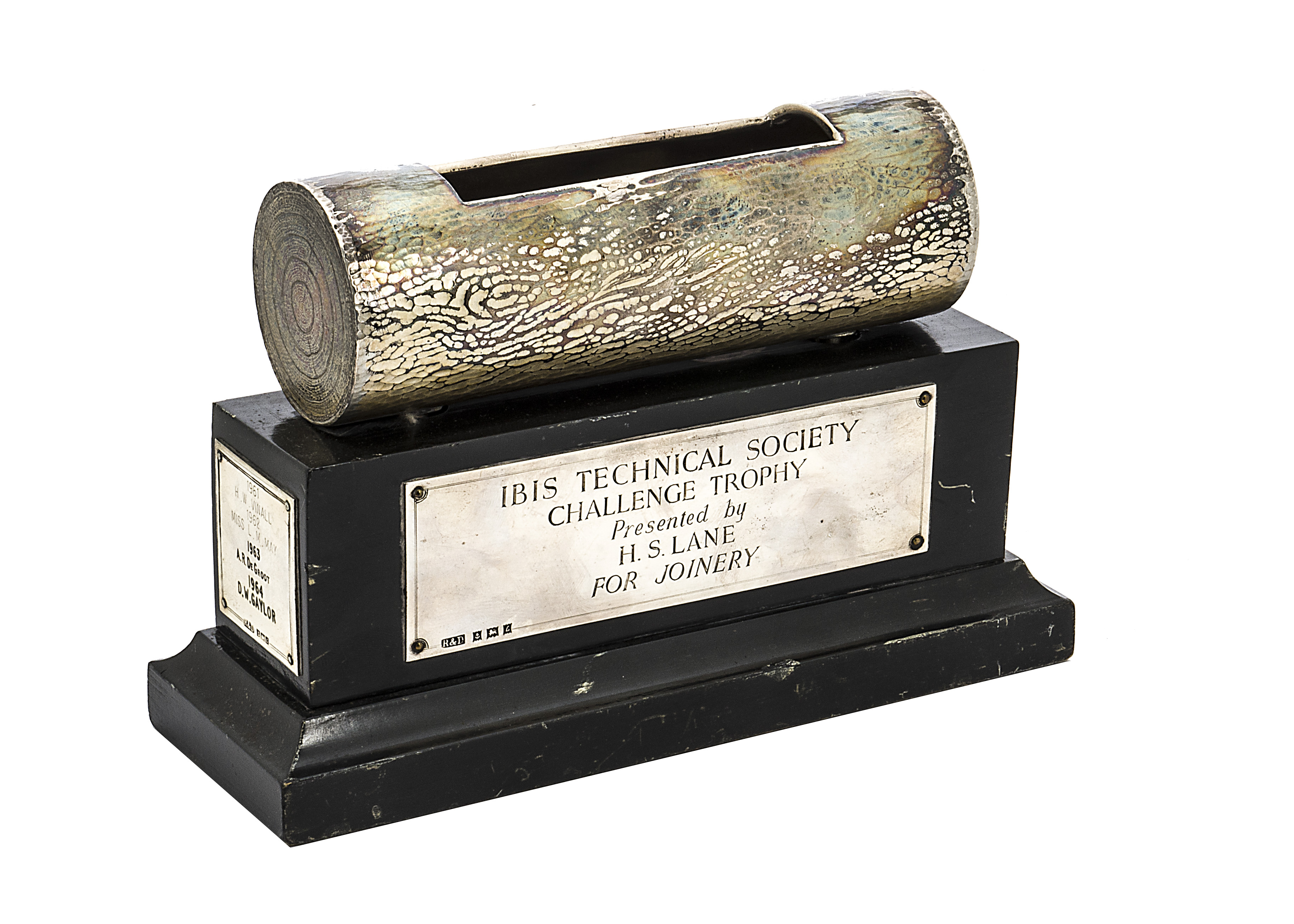 A 1960s novelty silver trophy, the black wooden plinth supporting a section of a log with cut out