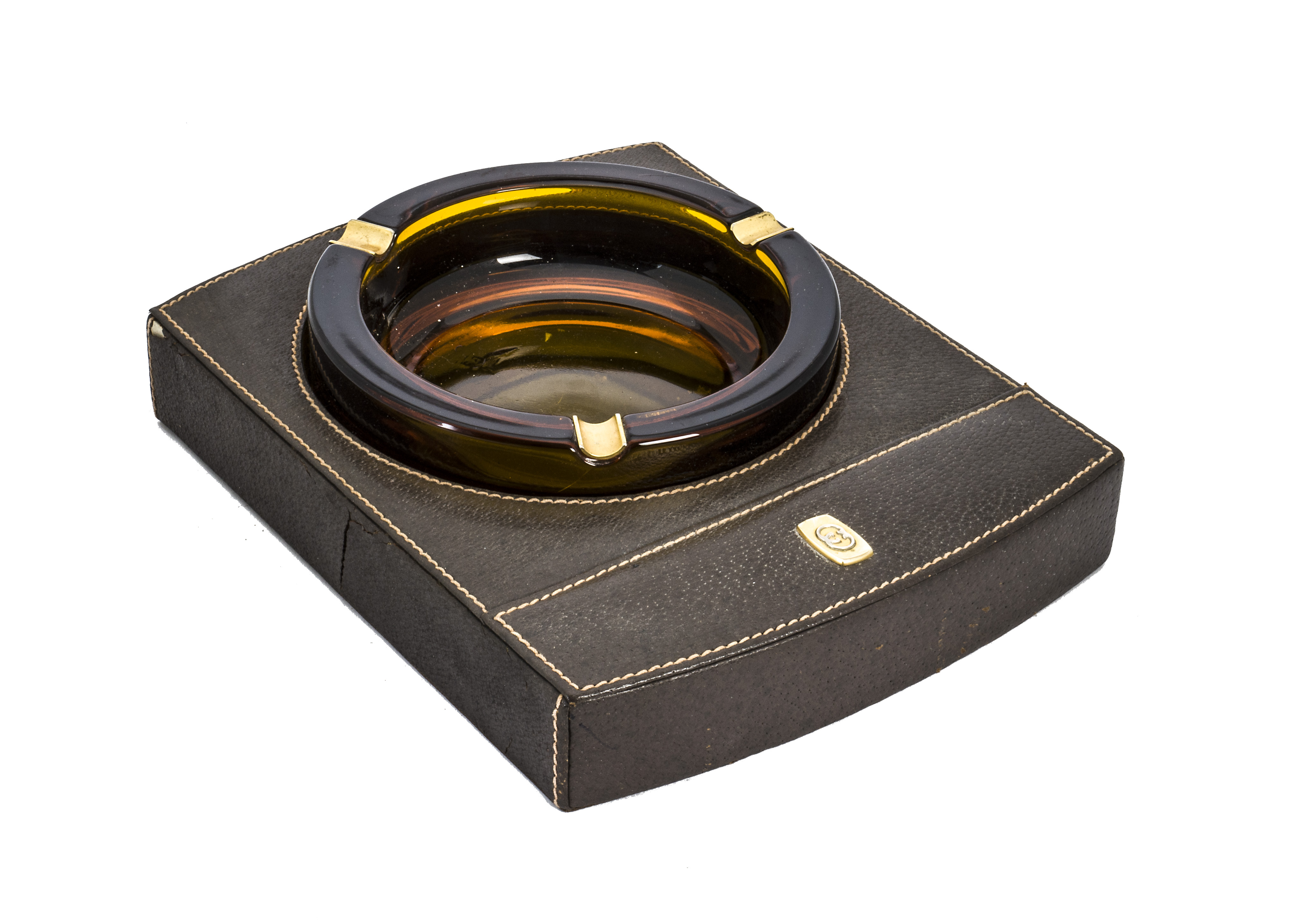 A 1980s leather and glass ashtray by Gucci, having inset amber glass ashtray in rectangular base, AF