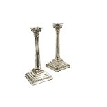A pair of late Victorian silver candlesticks by Charles Stuart Harris, London 1894, filled square