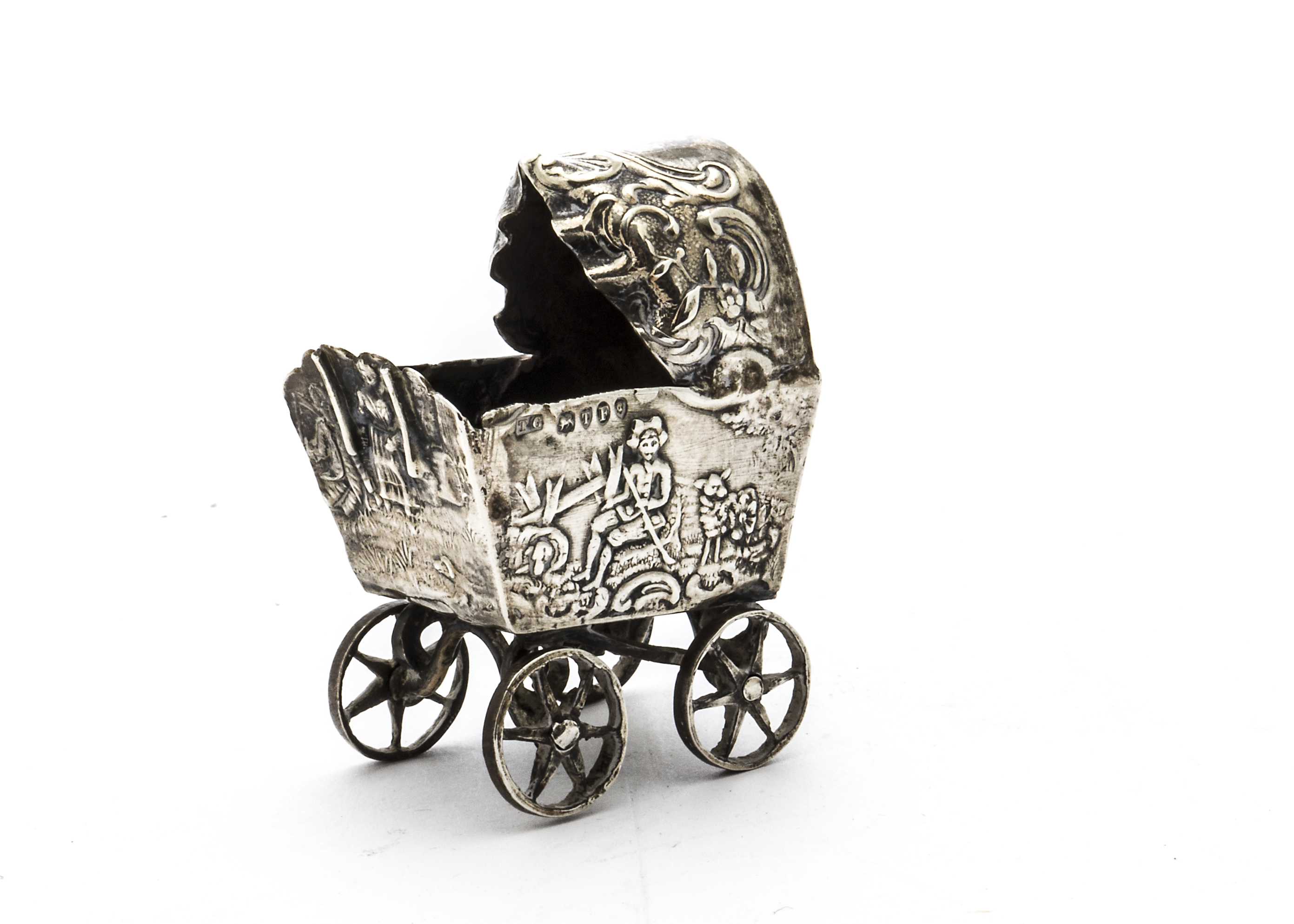 A Victorian silver miniature pram, with embossed design to body, lacks handle, import hallmarks