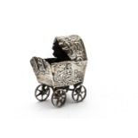 A Victorian silver miniature pram, with embossed design to body, lacks handle, import hallmarks