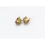 A pair of yellow metal and white sapphire clip earrings, the oval shaped clips set with circular cut