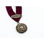 A George VI silver gilt and enamel clan medallion, the large circular flange decorated with Scottish