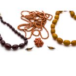 A cherry amber graduated string of oval beads, a simulated butterscotch amber uniform string of oval
