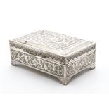 An Art Deco period Middle Eastern silver cigarette box, on four bracket supports having engraved