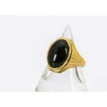 A continental yellow metal and nephrite signet ring, the cabochon oval stone in an art deco style