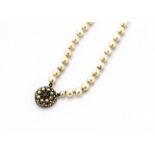 A cultured pearl two row choker, the uniform pearls knotted strung on a 9ct gold sapphire and seed