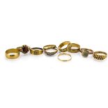 A collection of 19th Century and later gold bands, including a gentleman's garnet signet ring, the