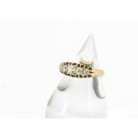 An Edwardian five stone 18ct gold diamond ring, the old cut diamonds in claw settings on a plain g