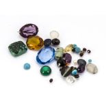 A small quantity of loose gemstones, including citrine, smoky quartz, lapis lazuli, bullseye agate