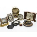 Seven travel and desk clocks, including an Art Deco white metal example, possibly silver but not