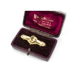 A cased Victorian citrine gold plated bar brooch, marked BRS in a William Alexander of Hexham fitted