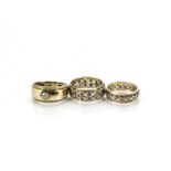 A 9ct gold gypsy set signet ring, together with two 9ct gold paste set eternity rings, 10g