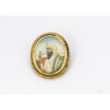 A 19th Century yellow metal miniature brooch, centred with a three quarter length portrait in