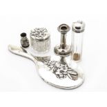 A group of silver items, including a silver hand mirror with raised lily design, a cut glass pot