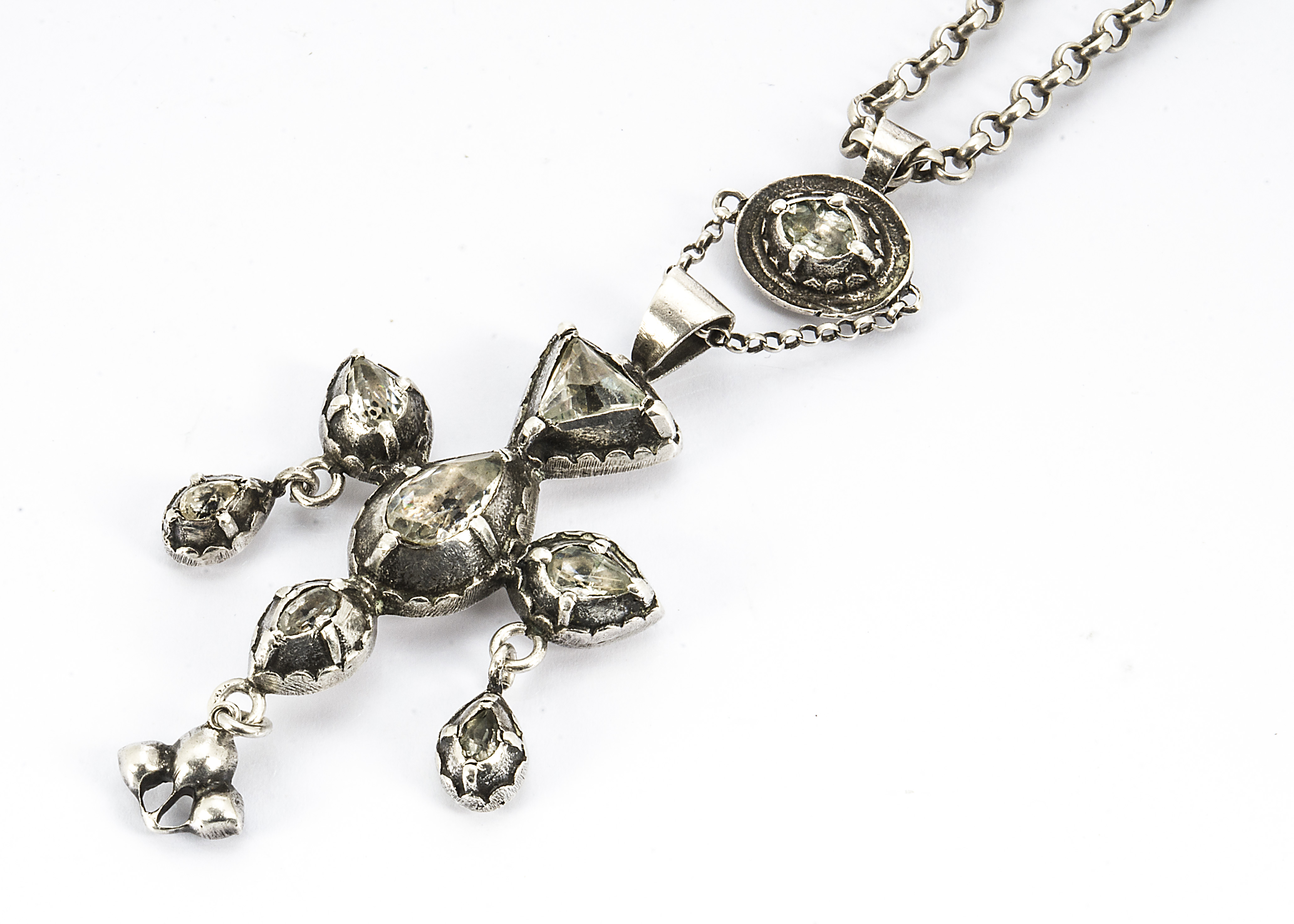 An 18th Century silver cruciform pendant with later chain, set with foil back colourless paste