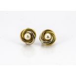 A pair of 18ct gold two colour ear studs, of knot design centred with cultured pearls, marked to